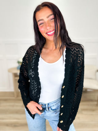 Black knit long-sleeve cardigan with button-front closure and textured diamond pattern
