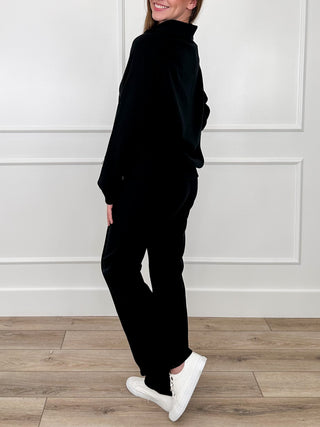 Black zip-front hoodie and matching pants, side view