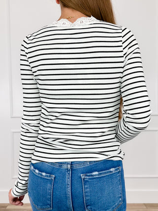 White-and-black striped long-sleeve top, back view, ruched waist and lace-trim neckline