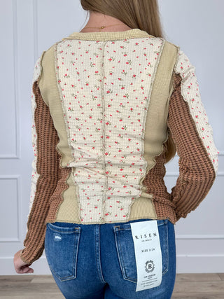 Long-sleeve back of cream top with red sprig print, tan yoke and side panels