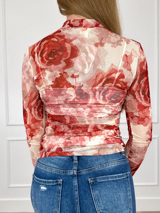 Sheer mesh long-sleeve top with red floral print on cream, back view, ruched waist
