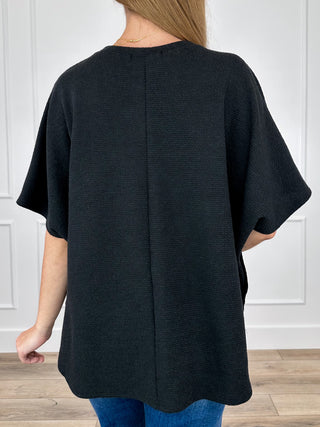 Black knit short-sleeve top with split back seam and relaxed fit