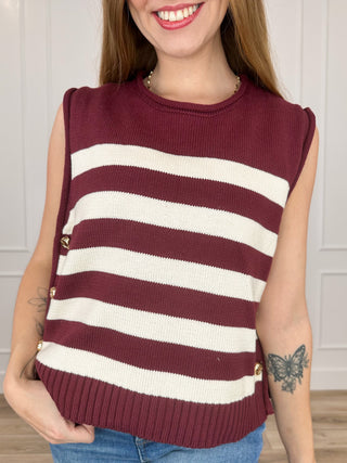 Wine red knit sweater vest with white striped bands, sleeveless crew neck, ribbed hem