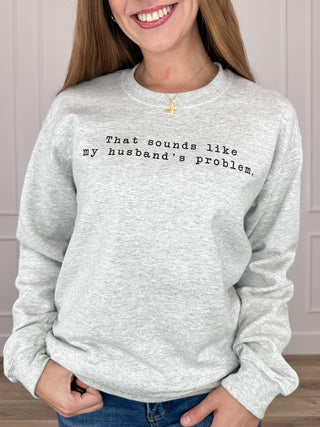 Grey crewneck sweatshirt with long sleeves and 'my husband's problem' print