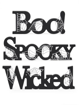Wood word decor set with black cutout letters: Boo, Spooky, Wicked, spiderweb graphics.