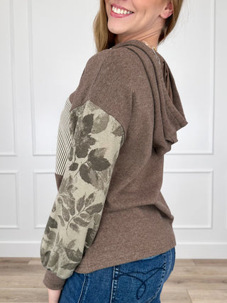 Brown hooded long-sleeve top with striped yoke and camo sleeve print, side view