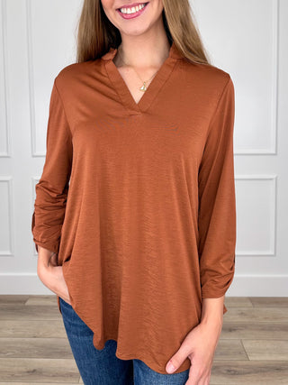 Rust orange gabby top with V-neck and 3/4 sleeves, loose tunic hem