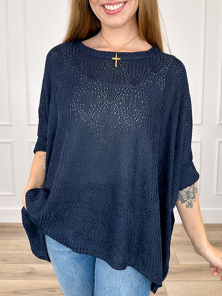 Navy blue knit short-sleeve poncho top with airy open-stitch pattern