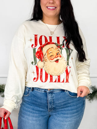 Cream long-sleeve cotton graphic tee with Santa face and holiday lettering