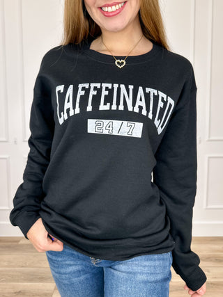 Black crewneck sweatshirt with long sleeves and CAFFEINATED 24/7 graphic front