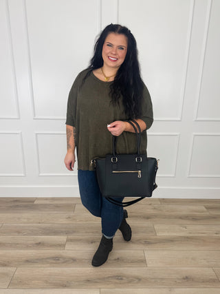 Olive green knit short-sleeve poncho top with relaxed drape and crew neckline