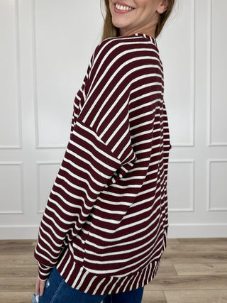 Knit long-sleeve top in burgundy and white stripes, side view, buttoned neckline