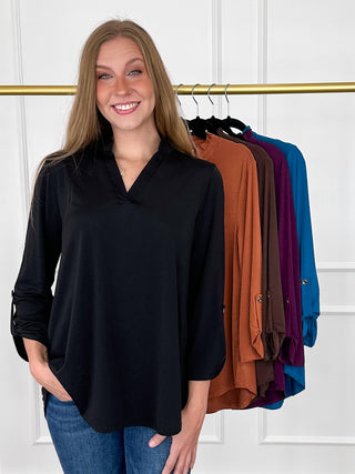 Black gabby top with V-neck and 3/4 sleeves, loose tunic fit
