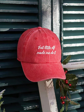 Red baseball cap with embroidered quote 'that little elf made me do it'