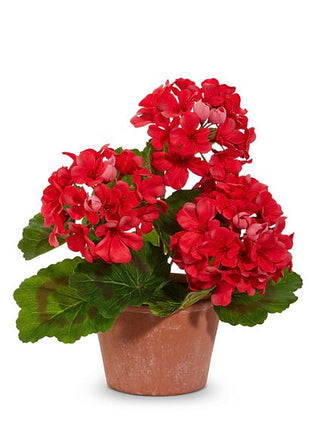 Red faux geranium flower decor with green leaves in terracotta pot