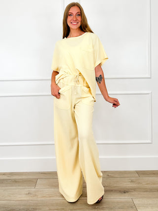 Yellow cotton-blend short-sleeve top with crew neck and front draped tie detail