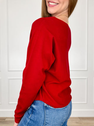 Red knit long-sleeve pullover top, side view
