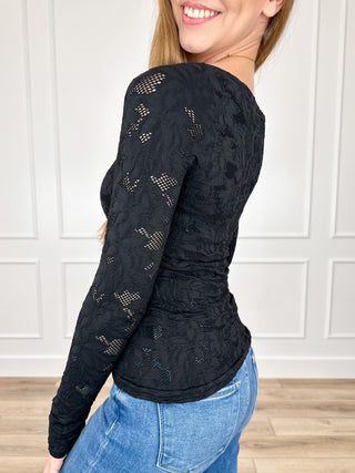 Black textured knit long sleeve top, side view
