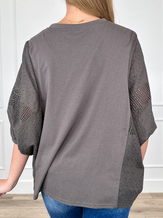Grey cotton-blend short sleeve top, back view with mesh perforations on sleeves