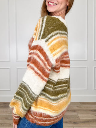 Cream knit long-sleeve sweater with orange, olive, and white striped pattern