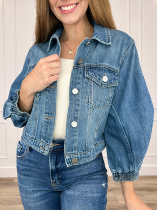 Medium-wash cropped denim jacket, button front, chest pockets, 3/4 sleeves