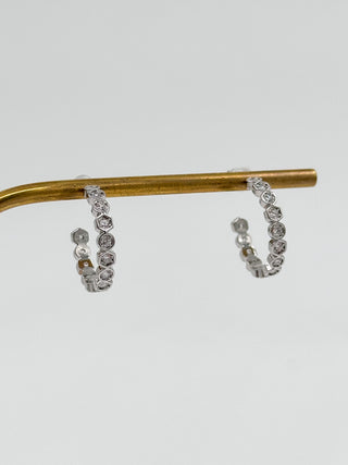 Silver hoop earrings with linked clear stone accents