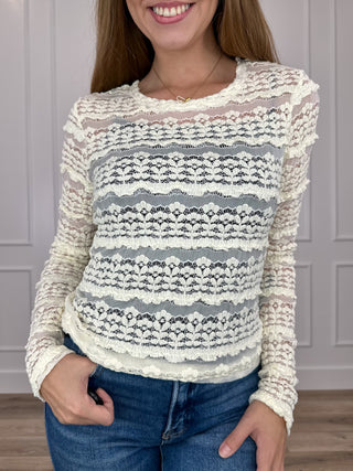 Cream sheer knit long sleeve top with scalloped horizontal stripe pattern.