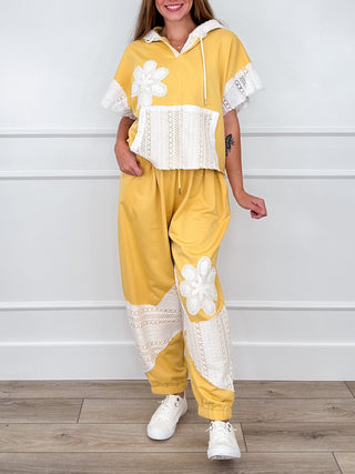 Yellow hoodie-and-pants set with embroidered lace floral trim and wide-leg joggers