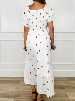 White maxi cotton-blend dress with puff sleeves, red floral print, tiered hem.