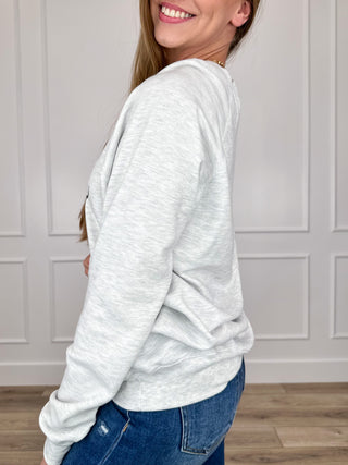 Grey long-sleeve crewneck sweatshirt, side view
