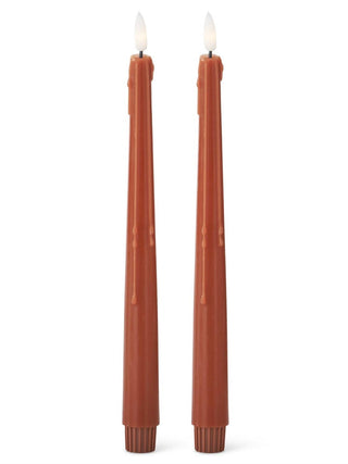 Set of two LED pillar candles in rust orange, with flame-shaped LED lights