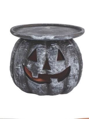 Dark gray pumpkin pillar stand with carved jack-o’-lantern face cutouts
