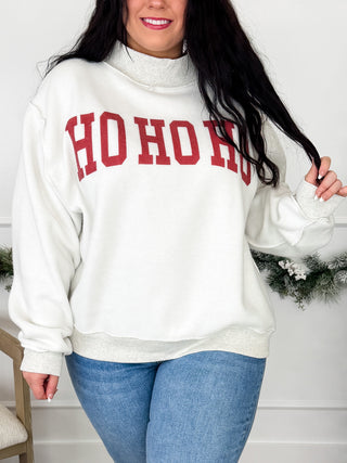White mock neck sweatshirt with red HO HO HO graphic across chest, long sleeves