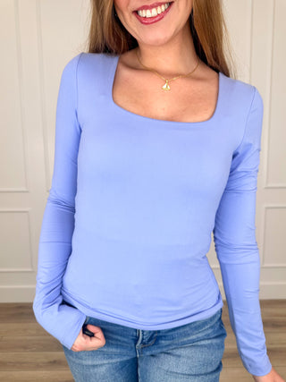 Light blue long-sleeve scoop-neck top with fitted stretch knit look