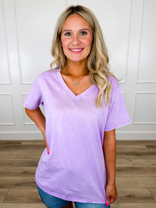Purple V-neck short-sleeve cotton top with relaxed fit and curved hemline.