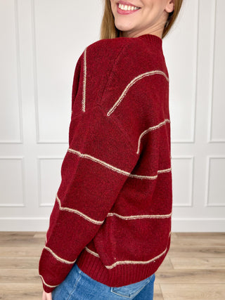 Wine red knit cardigan with long sleeves and cream stripe detailing at shoulders and sleeves