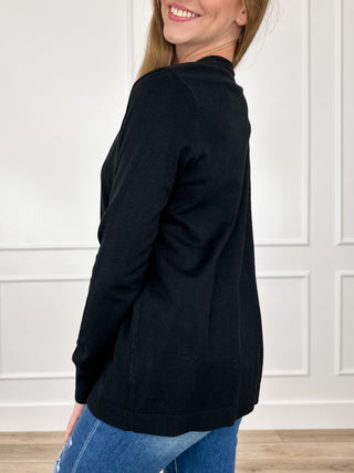 Black knit long-sleeve cardigan, side view with open front and long sleeves