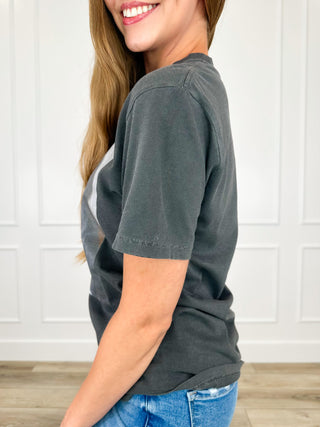 Dark grey short-sleeve tee shirt, side view with front graphic dog and iced drink cup.