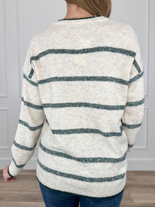 Oatmeal knit sweater with green horizontal stripes and long sleeves (back view)