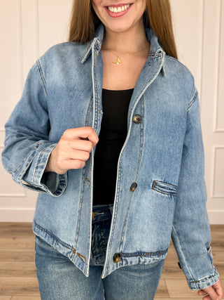 Medium wash cropped denim jacket, button front, flap chest pockets, long sleeves