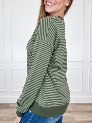 Green striped long-sleeve top with rounded neckline and banded cuffs