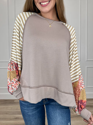 Knit long-sleeve top in latte, striped contrast sleeves and rounded hem