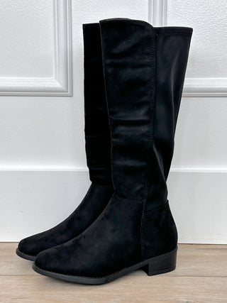 Black faux-suede tall boots with low block heel, pull-on design, and rounded toe.