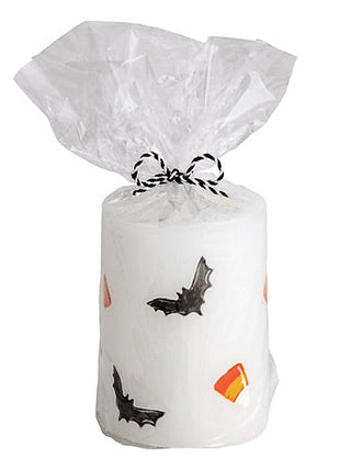 White Halloween candle with bat and candy corn prints, wrapped in clear bag
