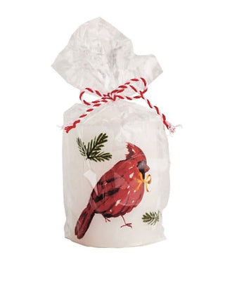 Wrapped pillar candle with red striped ribbon and red cardinal design on white bag