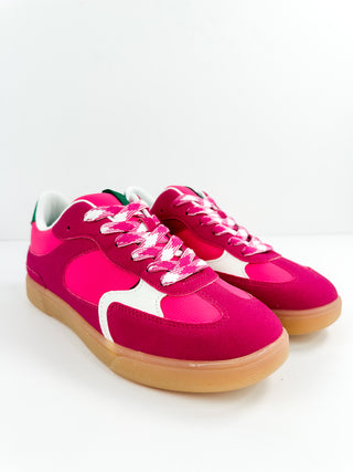 Bright pink faux leather sneakers with white panel and gum sole, lace-up design.