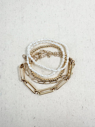 Gold-tone and pearl beaded bracelet set with small chain links and charm
