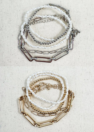 Stacked bracelet set with silver and gold chains, pearl beads, and beaded strands