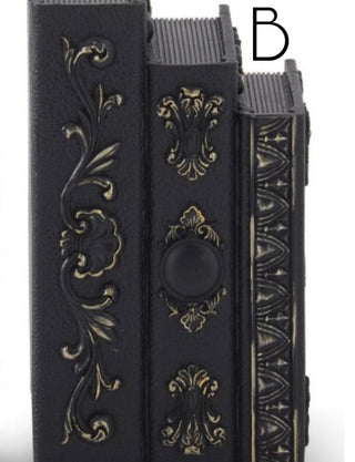 Dark resin book decor with gold ornamental scrollwork and spines, stacked set