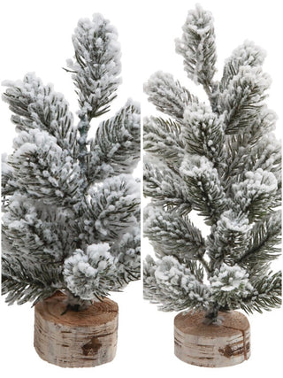 White faux pine tree decor on wooden base, snow-dusted branches